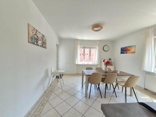 a dining room with a table and chairs at Sunlit Lugano & Parking Free in Massagno