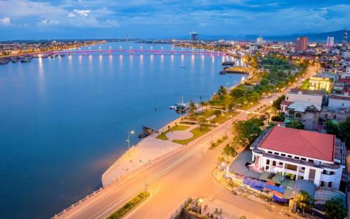 an aerial view of a city with a large body of water at Mộc House in Dong Hoi
