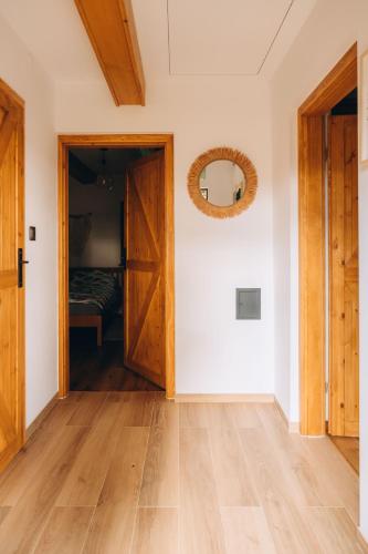 an empty room with a door and a bedroom at Między łąką a lasem in Żdżar