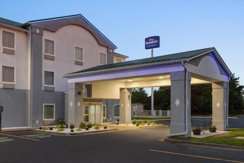 a hotel with a sign on top of a parking lot at Baymont by Wyndham La Grange KY Southeast in La Grange