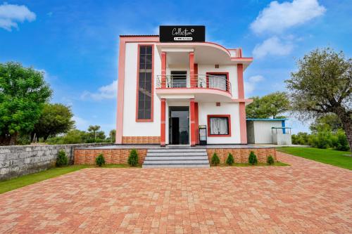 a house with a brick driveway in front of it at Collection O Salasar Balaji Temple Formerly Hanuwant Palace in Sīkar