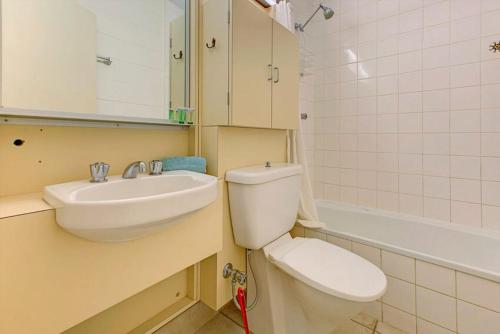 a bathroom with a sink and a toilet and a mirror at The Anchor in Exmouth