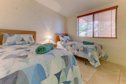 a bedroom with two beds and a window at The Anchor in Exmouth