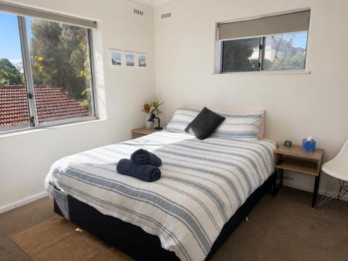 a bedroom with a bed with two towels on it at Ocean Eye in Perth