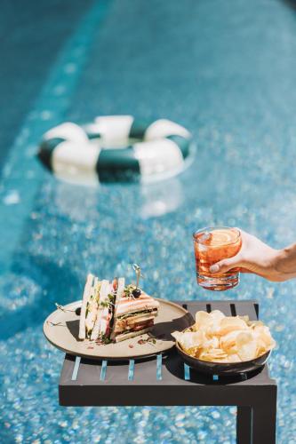 a table with a piece of cake and chips next to a pool at Hotel Gaspingerhof in Gerlos