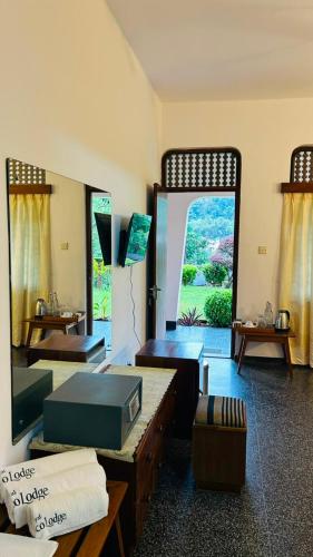 a living room with a large window and a large room with at Royal Eco Lodge in Kandy