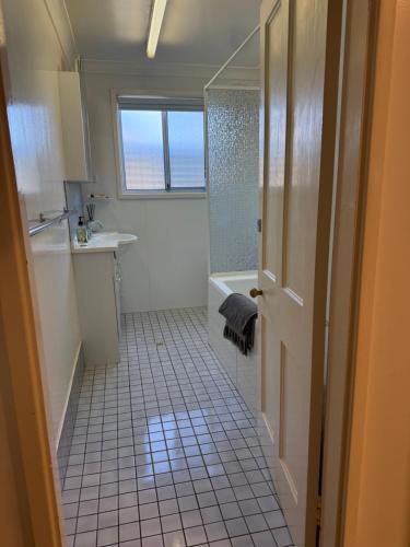 a bathroom with a shower and a sink at Lake Macquarie holidays in Marks Point