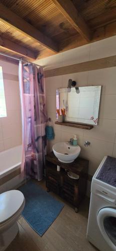 a bathroom with a sink and a toilet and a sink at Michaella's Maissonete at Rafaella Resort in Kokóni