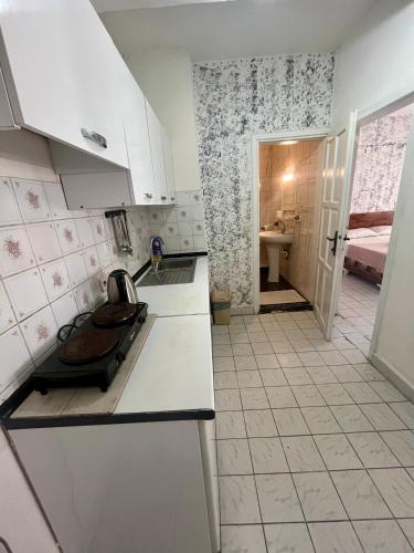 a kitchen with a sink and a counter top at Delphin Apart Hotel in Side