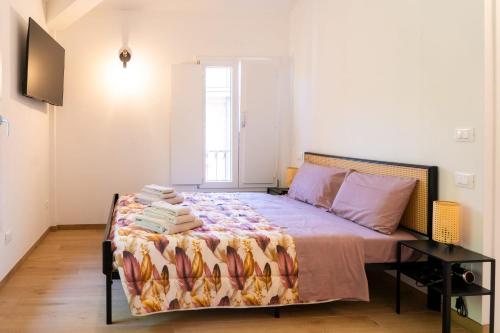 a bedroom with a bed with a blanket on it at Casa Matilde Rooms & Apartment in Bazzano Bologna