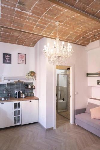 a living room with a chandelier hanging from a ceiling at Casa Matilde Rooms & Apartment in Bazzano Bologna