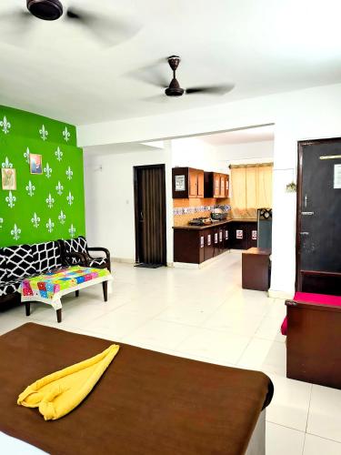 a living room with a couch and a table at Elite Calangute Beach Holiday Apartments With Pool in Calangute