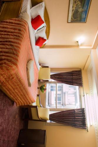 a bedroom with a large bed and a window at Hotel Kamal in Kathmandu