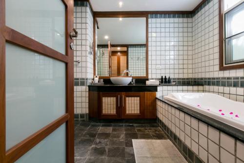 a bathroom with a tub and a sink at Katamanda Aliya Pool & Jacuzzi Villa Kata in Kata Beach