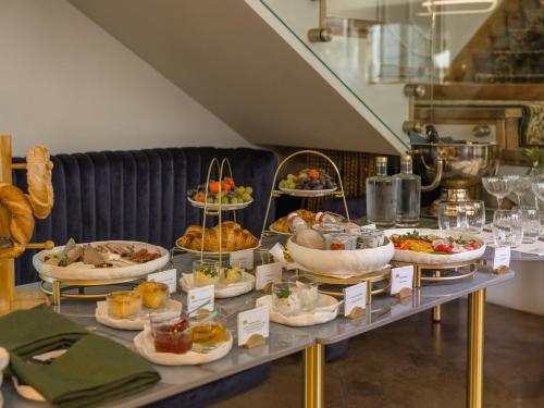 a buffet with many different types of food on a table at The House 14 in Krakow