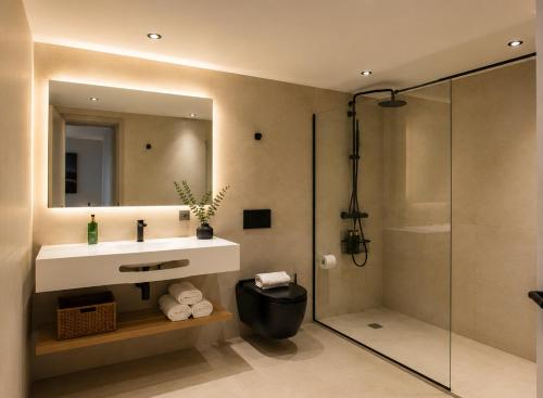 a bathroom with a sink and a shower at Mallorca Suites Playa De Palma in Palma de Mallorca