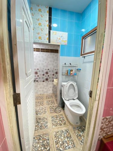 a small bathroom with a toilet and a shower at Buriram Cozy Home in Buriram