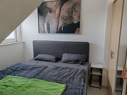 a bedroom with a bed and a picture of an elephant at Traumhafte Lage am Kurpark in Bad Nauheim
