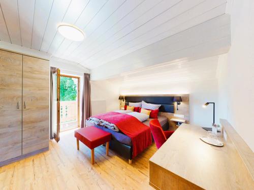 a bedroom with a bed and a table and chairs at Landhaus Wildschwendt in Ellmau