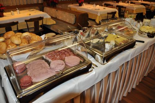 a buffet with meat and other foods on a table at Hotel Restaurant Rössle in Rankweil