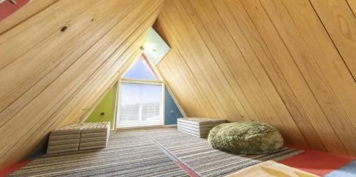 a attic room with a large window and a green ball at パワースポットキャンプ場 in Shimoda