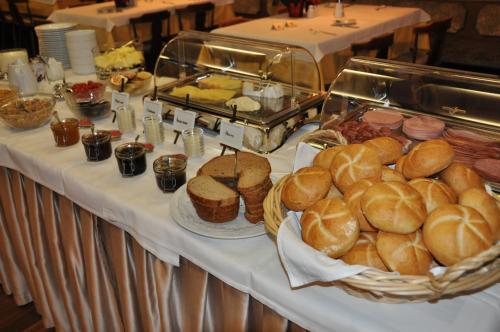 a buffet with bread and pastries on a table at Hotel Restaurant Rössle in Rankweil