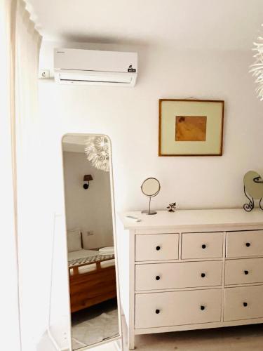 a bedroom with a dresser and a mirror at The Airport Loft in Otopeni