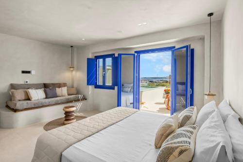 a bedroom with a bed and a living room at Alexandros Apartments in Naousa