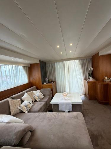 a living room with a couch and a table at Yacht Laetitia Delta in Fréjus