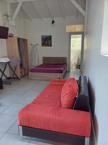 a living room with two beds and a couch at Terrasson GOLD2 in Les Abymes