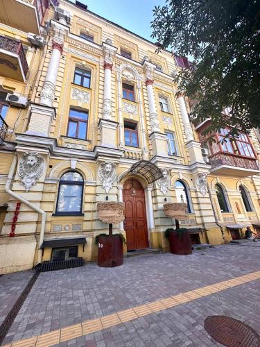 a large yellow building with a red door at MYFREEDOM Premium Apartments near Khreshchatyk in Kyiv