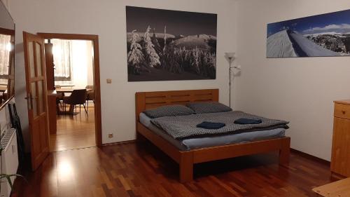 a bedroom with a bed and a dining room at Apartmán vila Vítkovice in Vítkovice