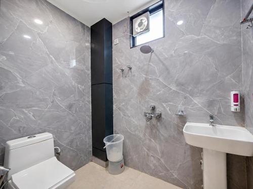 a bathroom with a white toilet and a sink at Hotel Shree Vrindavan Inn in Vrindāvan