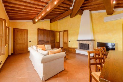 a living room with a couch and a fireplace at Tenuta Santavenere in San Bartolomeo