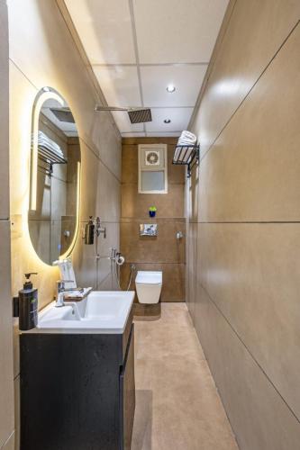 a bathroom with a sink and a toilet at Hotel Grand Elite- Ghaziabad in Ghaziabad