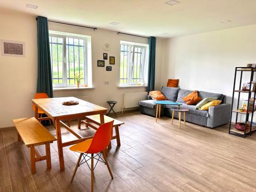 a living room with a couch and a table at Cozy Dez Guest House with Dreamy Mountain Views in Margahovit