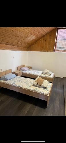 two beds sitting in a room with a window at Jackys hostel 9 in Sremski Karlovci