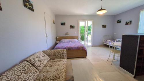 a living room with a bed and a table at Campagne Carbonel in Aix-en-Provence