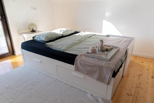 a bedroom with a white bed with a tray on it at Sunset Home in Vršac