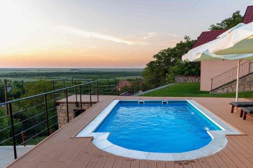 a swimming pool on a deck with a view at Sunset Home in Vršac