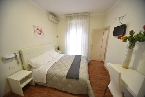 Ένα ή περισσότερα κρεβάτια σε δωμάτιο στο Hotel Villa Edda