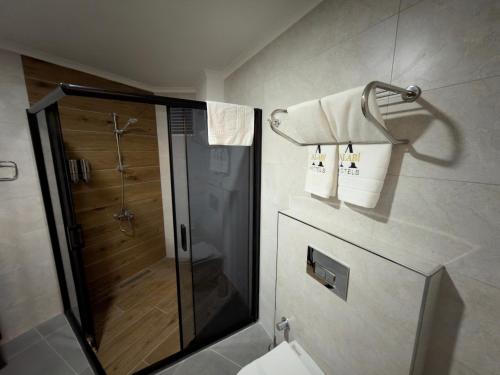 a bathroom with a shower and a toilet at Alabi Hotels in Istanbul