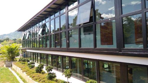 a building with windows and plants on the side of it at Lilly Home in Campson