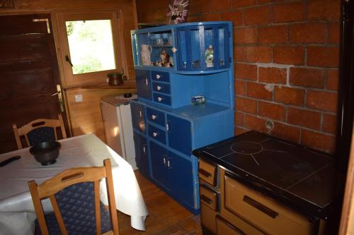 a blue cabinet in a kitchen with a table at Autocamp & Apartment Snežana in Berane