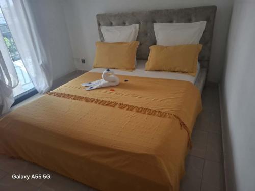 a bed with a stuffed duck sitting on top of it at Villa TSARAJORO in Toamasina