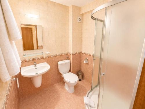 ein Badezimmer mit Toilette, Waschbecken und Dusche in der Unterkunft Семеен Хотел Идън in Sweti Wlas