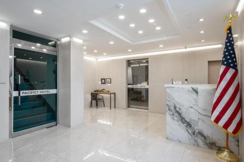a lobby with an american flag in a building at Pacific7 Hotel in Pyeongtaek