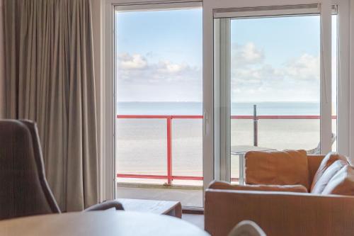 a room with a large window with a view of the ocean at Zuiderzee State - Appartementen in Makkum