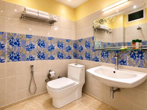 a bathroom with a toilet and a sink at Swaasha Vista in Kausani