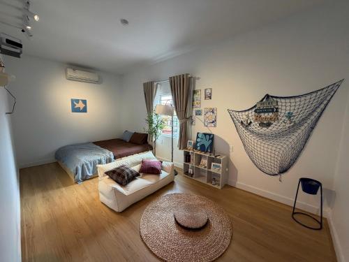 a room with a bed and a hammock in it at 12 Homestay & Hotel in Lạng Sơn